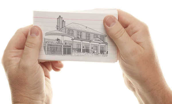 Male Hands Holding Stack of Flash Cards with House Drawing