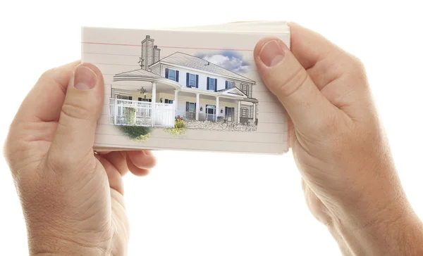 Mãos masculinas segurando pilha de cartões flash com desenho da casa — Fotografia de Stock