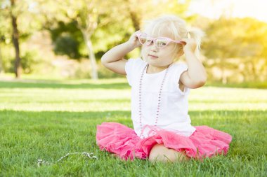 Little Girl Playing Dress Up With Pink Glasses and Necklace clipart