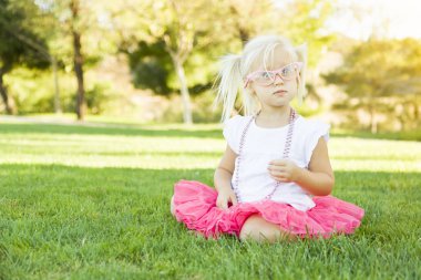 Little Girl Playing Dress Up With Pink Glasses and Necklace clipart