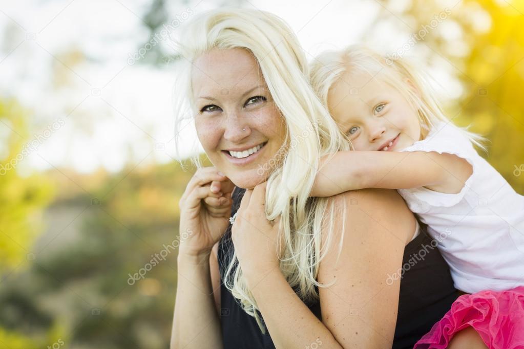 Mother and Little Girl Having Fun Together in Grass