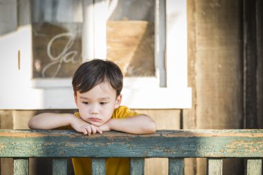 Melancholy Mixed Race Boy Leaning on Railing clipart