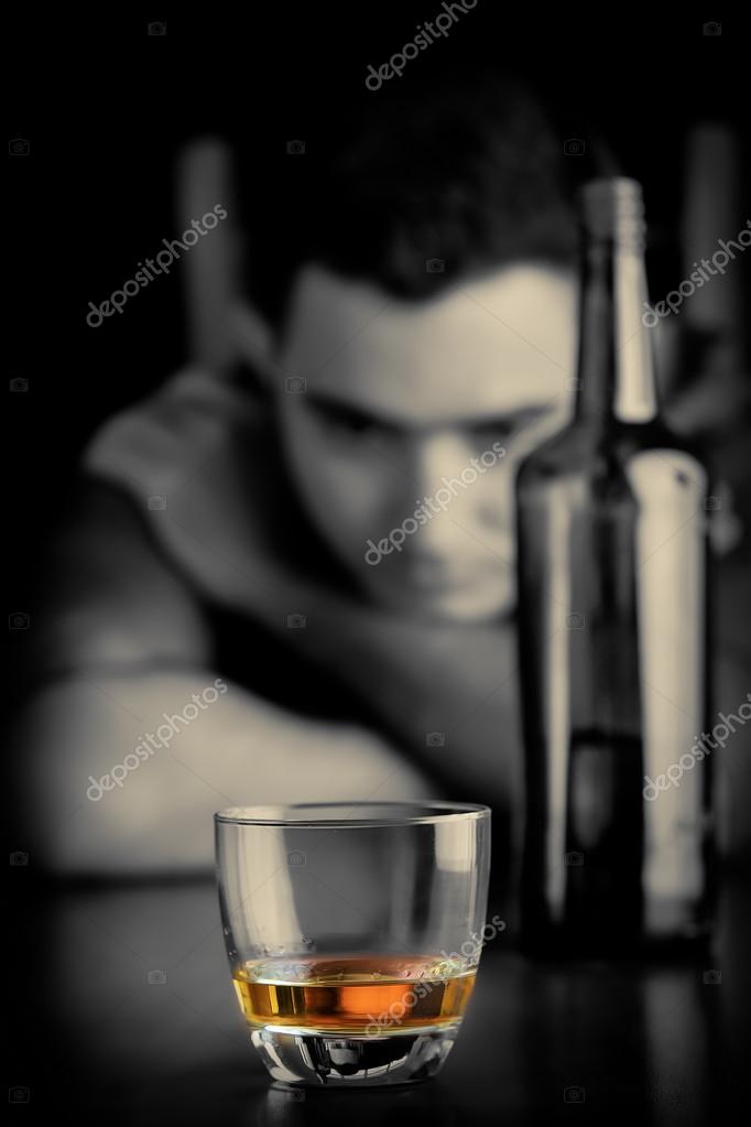 Lonely and sad man drinking alone Stock Photo by ©kmiragaya 101252300