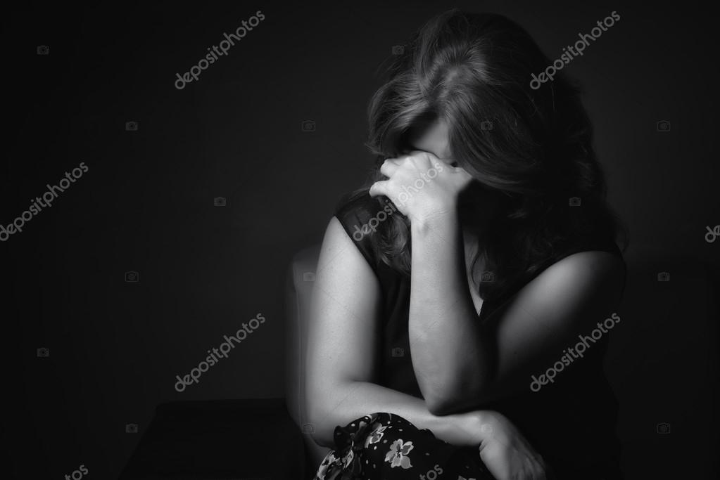 Crying sad woman on a black background Stock Photo by ©kmiragaya 109303186