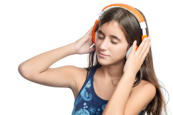 Beautiful hispanic teenage girl enjoying music on bright orange headphones — Stock Photo, Image