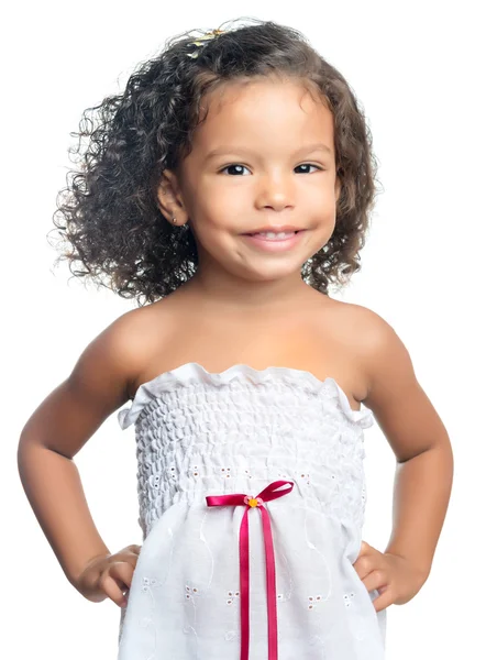 Joyful little girl with an afro hairstyle eating a chocolate cookie — Stock Photo, Image