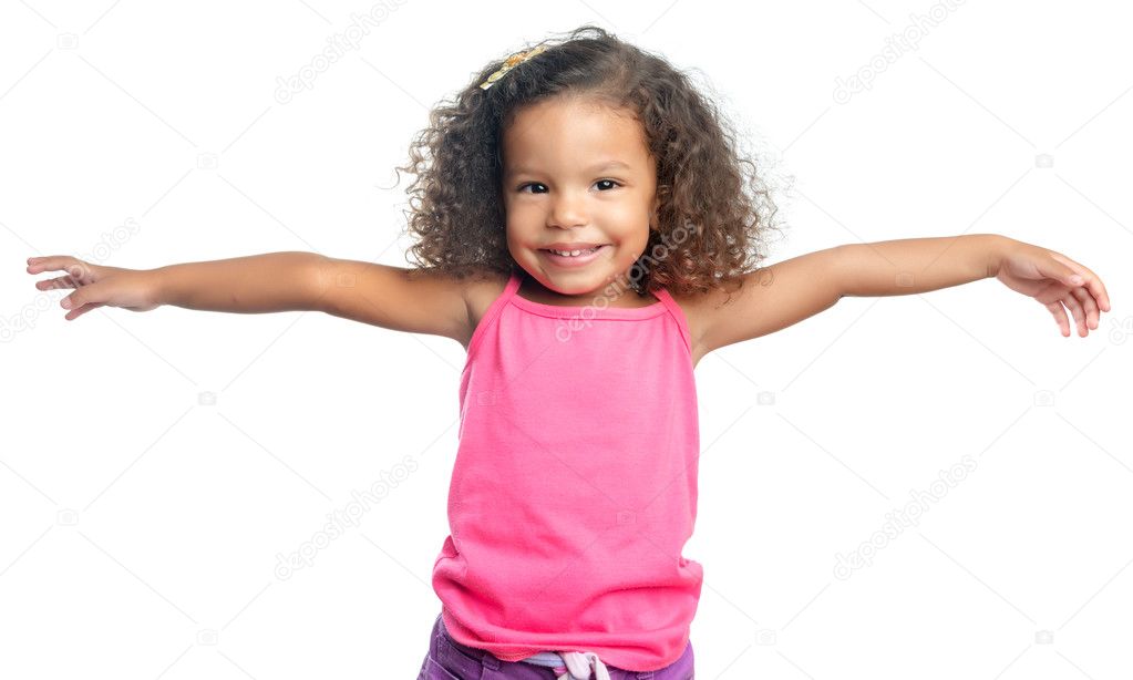 Joyful little girl with an afro hairstyle laughing with her arms extended