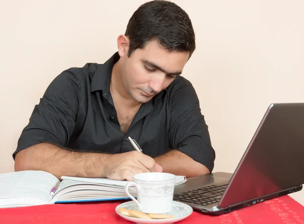 Homem hispânico estudando ou fazendo trabalho de escritório em casa — Fotografia de Stock