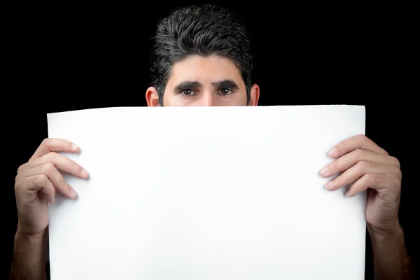 Young man hiding behind white banner — Stock Photo, Image