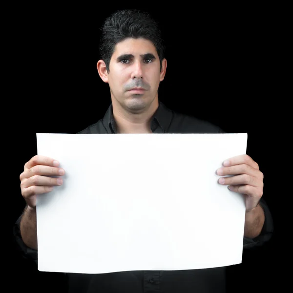 Serious hispanic man holding a white banner — Stock Photo, Image