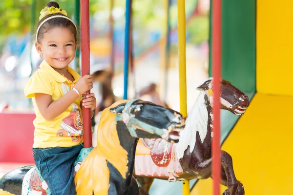 Cute  girl riding carousel — Stock Photo, Image