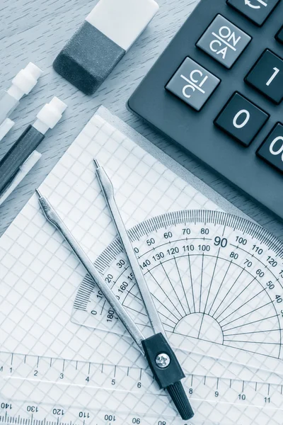 School supplies used in math toned in blue — Stock Photo, Image