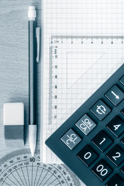 School supplies used in math toned in blue — Stock Photo, Image