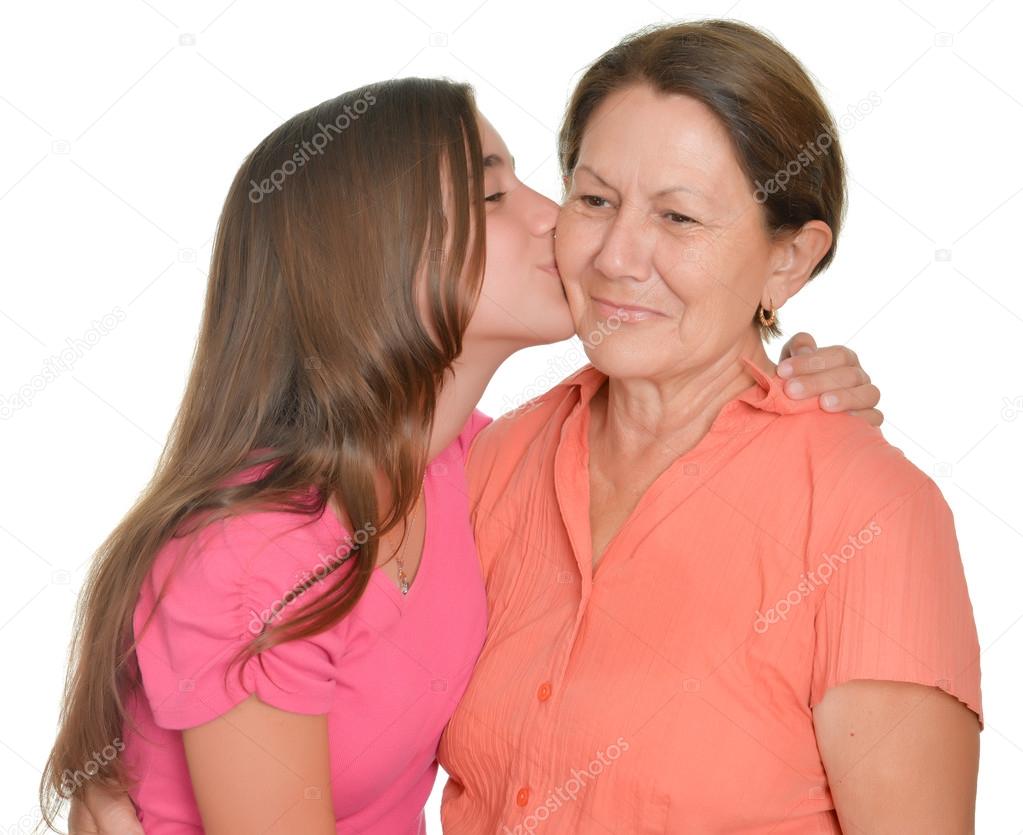Hispanic teenage girl kissing her grandmother Stock Photo by ©kmiragaya  72781109