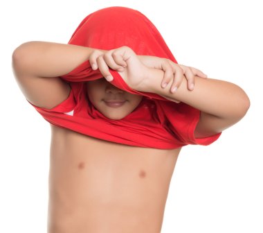 Small boy taking off his tshirt isolated on white