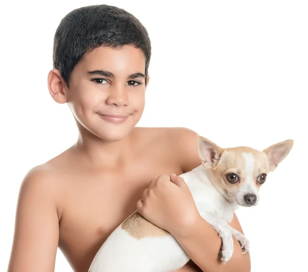 Bonito menino hispânico carregando um pequeno cachorro chihuahua — Fotografia de Stock