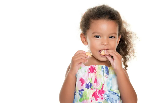 Cute small girl eating a cookie — Stock Photo, Image