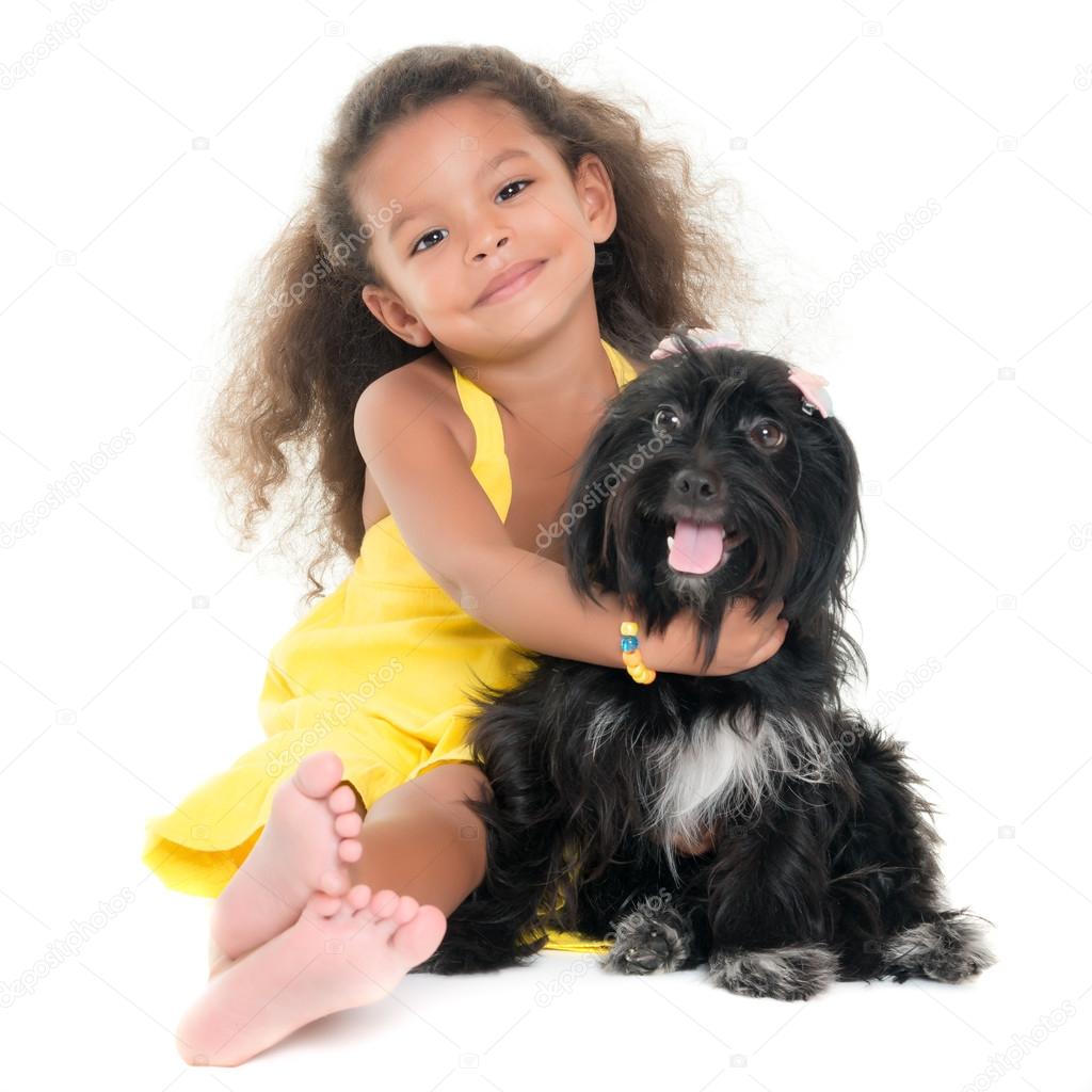 Cute small girl hugging her pet dog