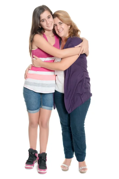 Hispanic teenage girl hugging her mother isolated on white — Stock Photo, Image