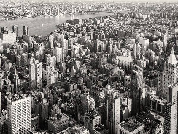 Black and white urban landscape of New York City with the East River on the background