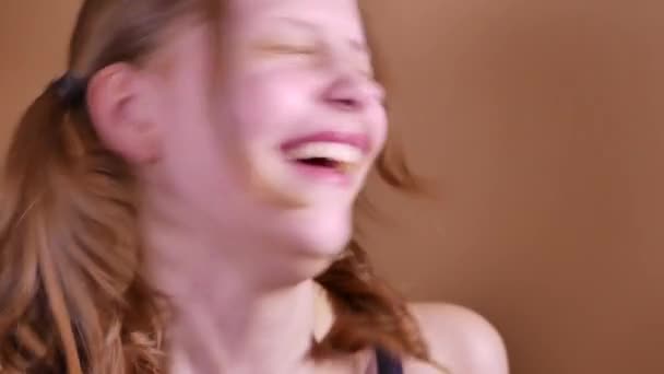 Closeup portrait of a funny attractive laughing teen girl. 4K UHD — Stock Video