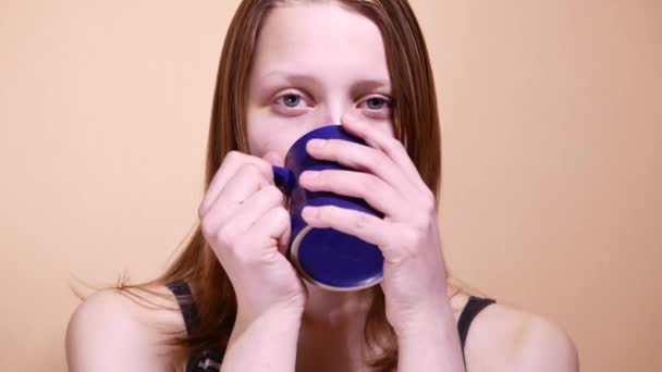 Cute young teenager girl is drinking coffee or tea at home. 4K UHD — Stock Video