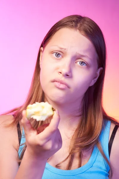 Unhappy teen girl eating tasteless apple — Stock Photo, Image