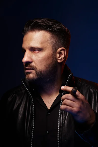 Portrait of a tough guy smoking cigar — Stock Photo, Image