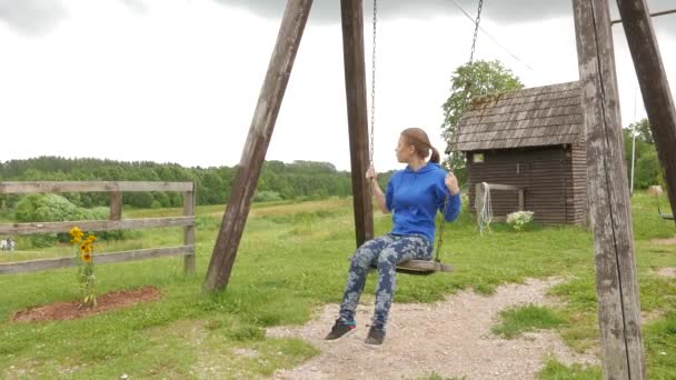 Teen girl on a seesaw — Stock Video