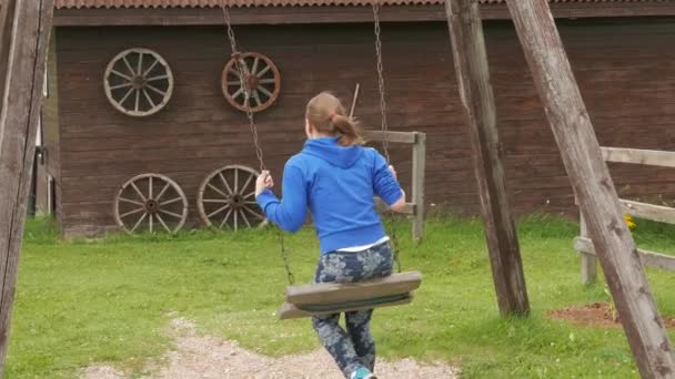 Teen girl on a seesaw — Stock Video