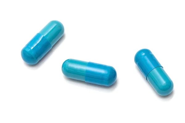 Blauwe capsules geïsoleerd op wit — Stockfoto