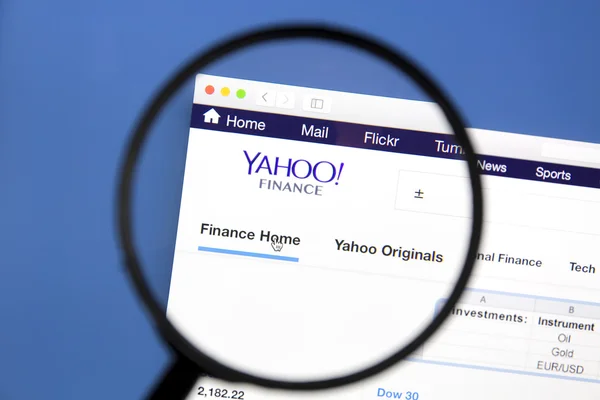 Yahoo finance website under a magnifying glass — Stock Photo, Image