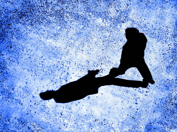 Man walking on sidewalk with black shadow