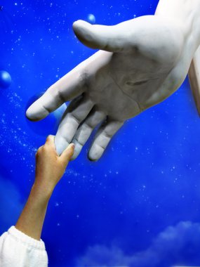Child Holding Hand of Jesus Statue clipart