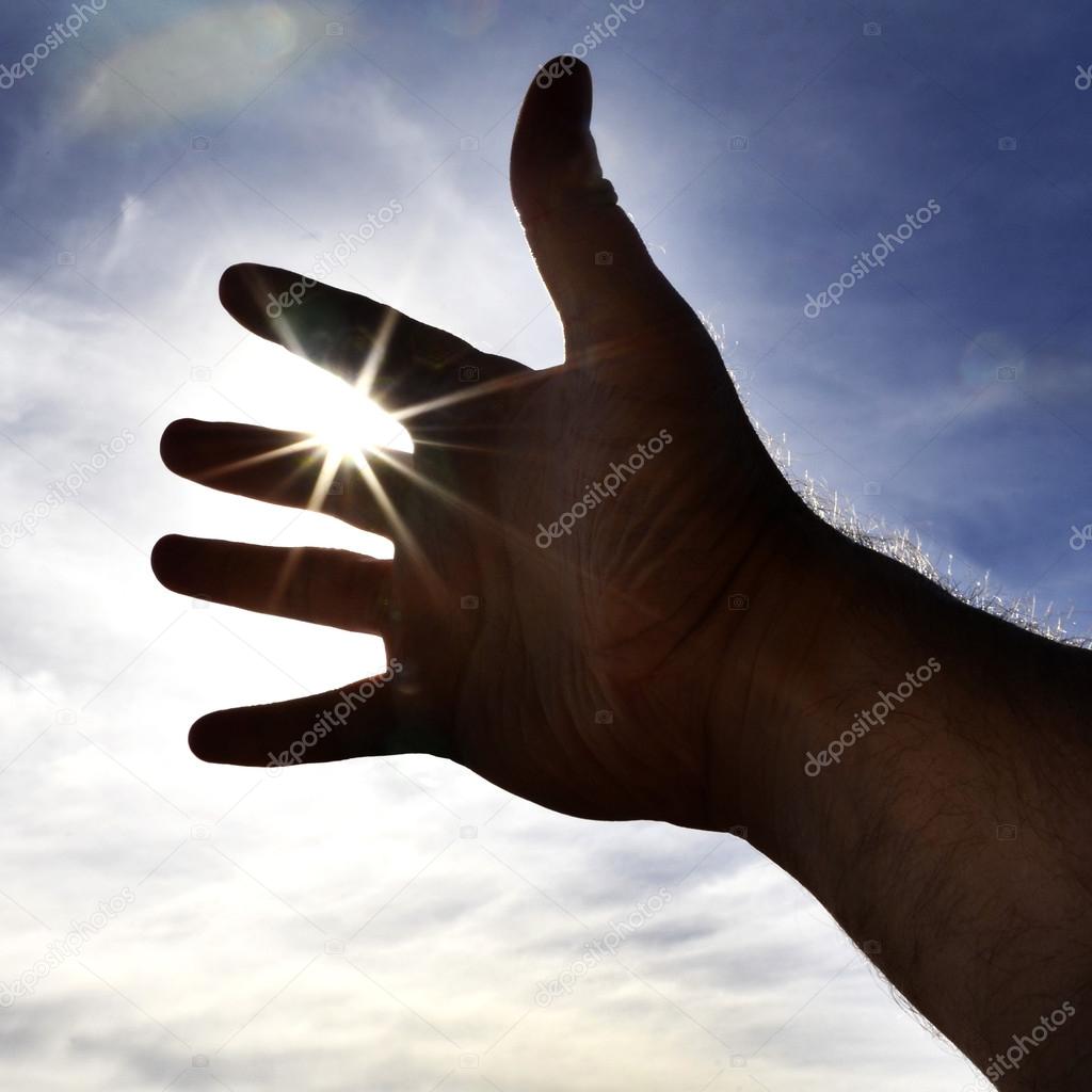 Person's Hand Reaching Towards Heaven Sunlight