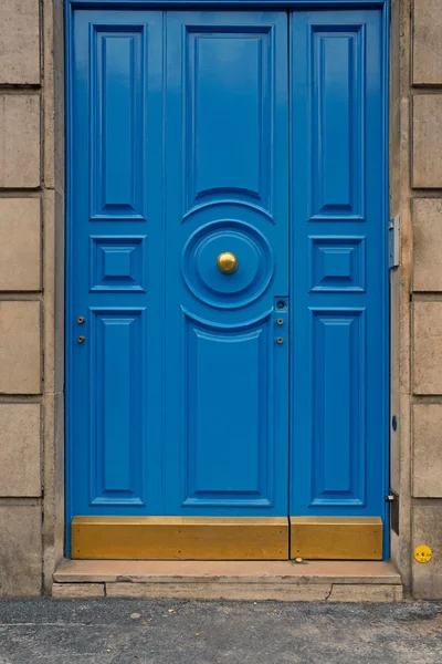 Blaue Tür mit gelbem Türknauf — Stockfoto