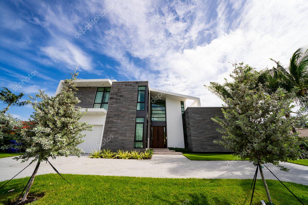 Modern home with lawn on blue sky