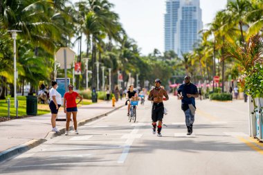 Miami Beach, FL, ABD - 7 Aralık 2020: Miami Beach sokak fotoğrafçılığında koşan sağlıklı erkekler