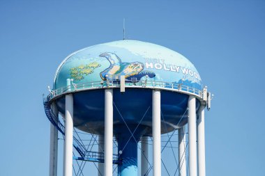 Dania Beach, FL, USA - January 9, 2021: Hollywood Florida water tower on blue sky shot with telephoto lens clipart