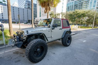 Fort Lauderdale, FL, USA - January 9, 2021: Two door Jeep Wrangler Rubicon lifted with oversized tires for trail riding 4x4 clipart
