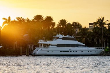 Superyacht at sunset on the water Miami scene clipart