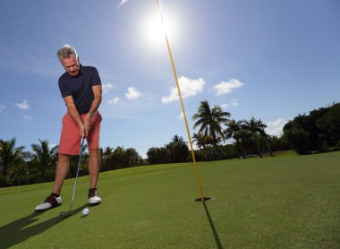 Golfer making the shot clipart