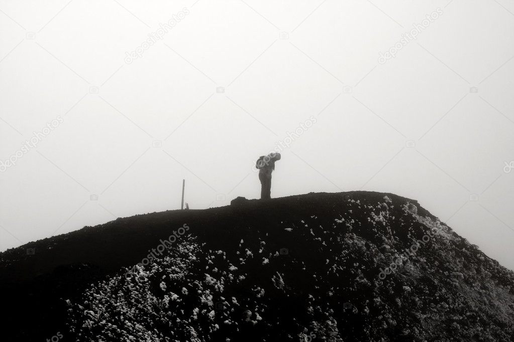 Lonely Hiker on Gloomy Mountain Top