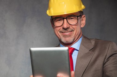 close portrait of mature engineer wearing helmet