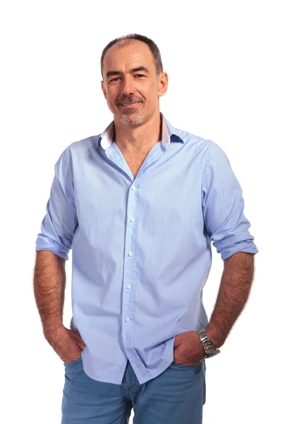 Confident mature bald man posing smiling with hands in pockets — Stockfoto