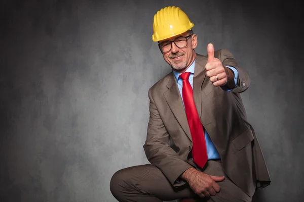 Engineer wearing helmet and glasses showing thumbs up — Stock fotografie