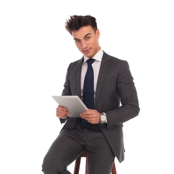 Seated young business man holding tablet — Stock Photo, Image