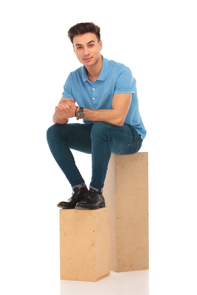 Hipster sentado em caixas de madeira — Fotografia de Stock