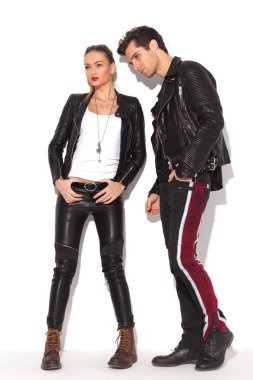 side view of a fashion couple in leather jackets 