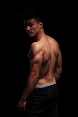 side portrait on standing muscular man